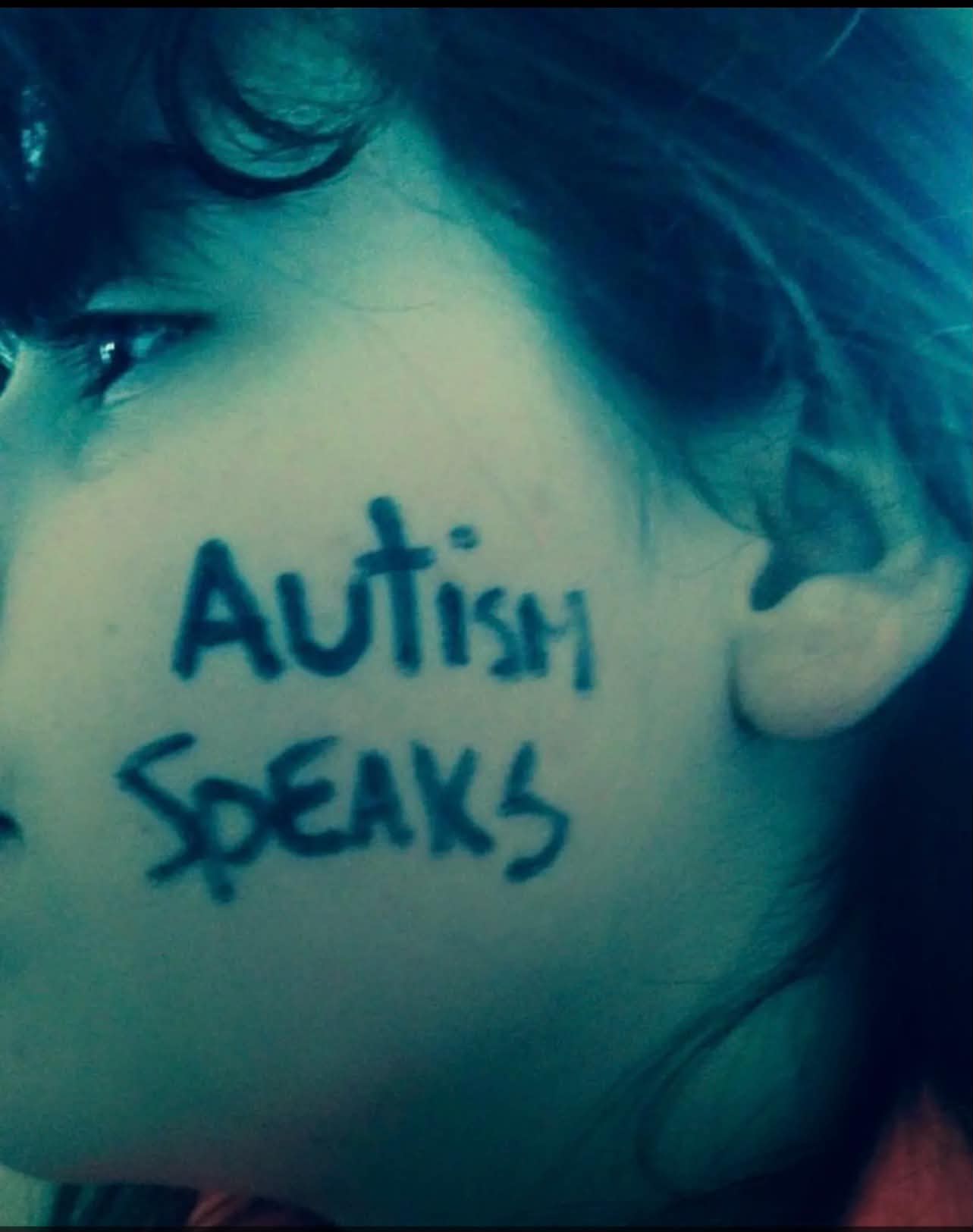 Close-up portrait with Autism Speaks written on the subject's cheek