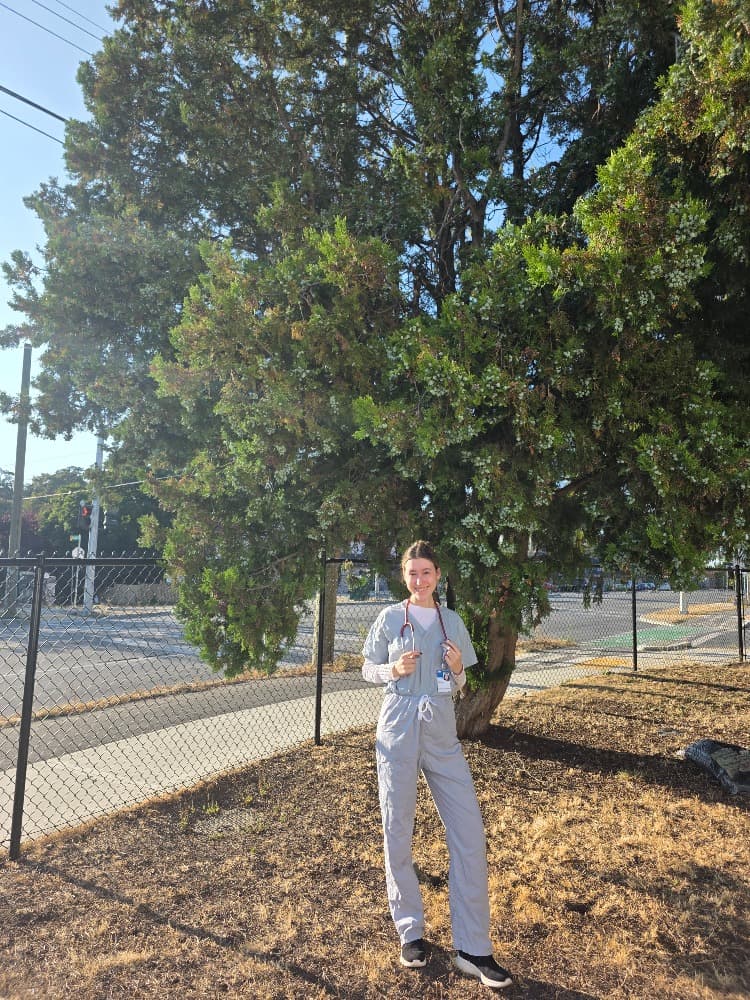 Sierra Wicks-Irving wearing nursing scrubs outdoors